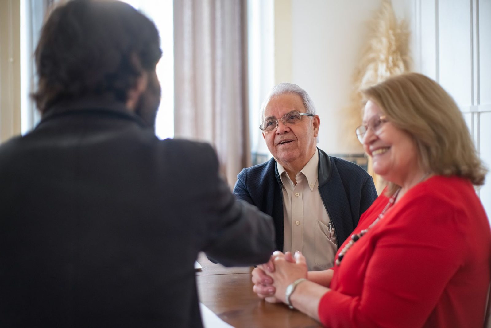 An adviser in conversation with an older couple across a desk