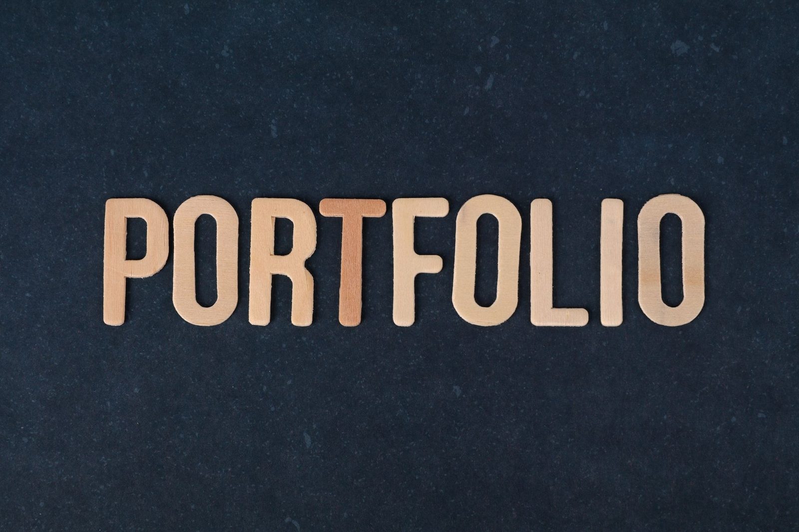 The word portfolio spelled in wooden letters against a dark background