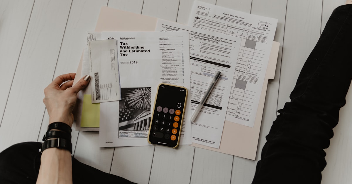 Financial planner writing notes in a budgeting notebook