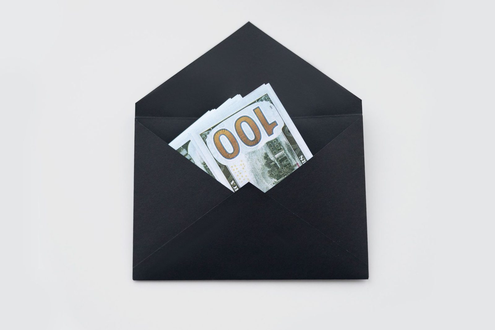 A black envelope with banknotes visible inside it