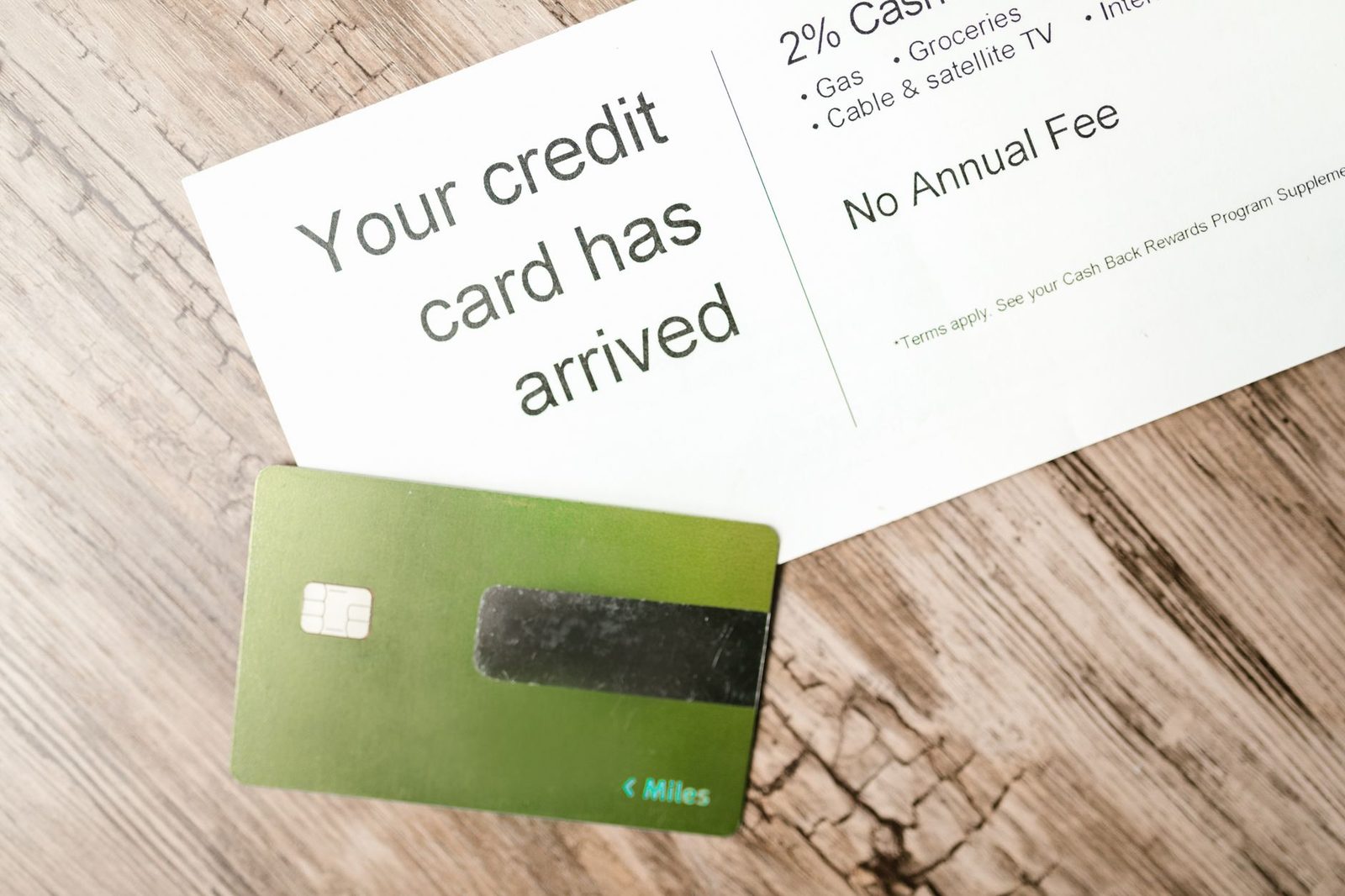 A credit card arrival letter with a card clipped to it, showing the words no annual fee