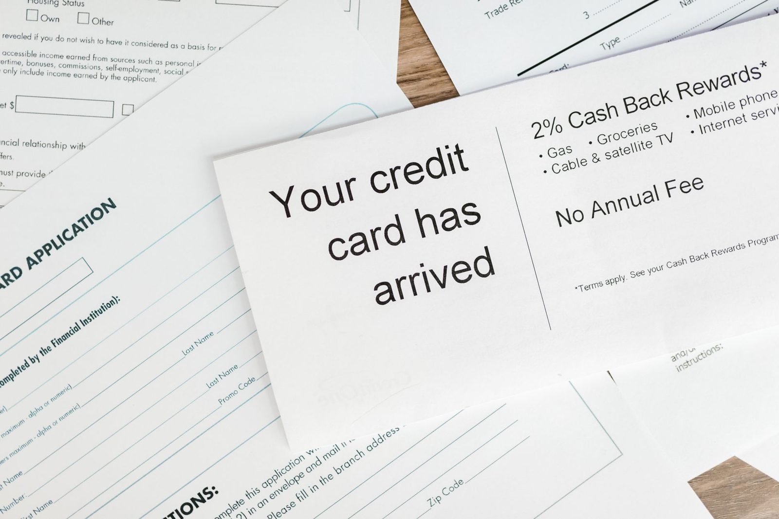 Credit card offer paperwork showing rewards terms spread on a surface